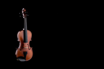 A wooden violin or viola on a black background
