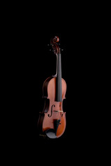 A wooden violin or viola on a black background