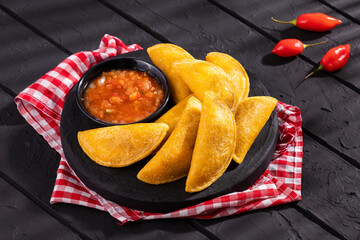 Fried empanadas with spicy sauce - typical Colombian food