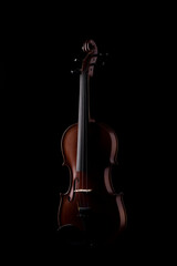 A wooden violin or viola on a black background