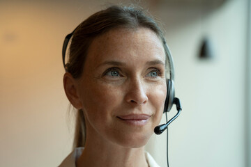Close-up of mature woman wearing headset