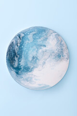 Blue scenic circle. Fluid art with ocean waves painted on round shape canvas