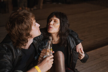 Couple smiling to each other while clinking with beverages and being in a great mood