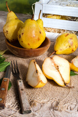 Naklejka na ściany i meble Sliced pears on sackcloth with a knife and fork