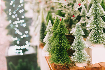 Christmas and New Year's decorative artificial trees on the counter in the store on the Christmas...