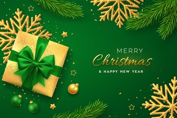 Christmas banner. Realistic gold gift box with green bow, shining snowflake, gold stars, pine branches, confetti, balls. Xmas background, horizontal poster, greeting cards, headers website. Vector.