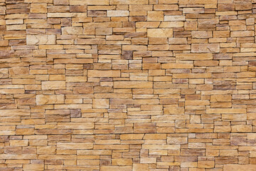 Stone tile of mosaic exterior cover on modern building, material Seamless textured wall background