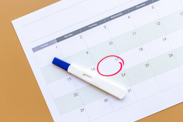 Pregnancy test on calendar. Time to check pregnancy day