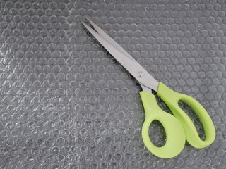 scissors on the bubble for wrap the packaging material.
