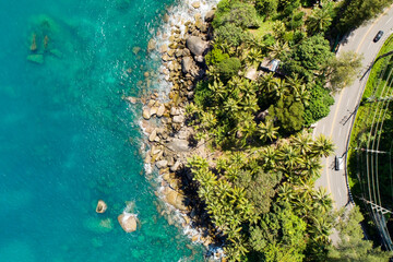 Obraz premium Aerial view of curve road along the seashore at Phuket Thailand beautiful seacoast and open sea in summer season Nature recovered Environment and Travel background