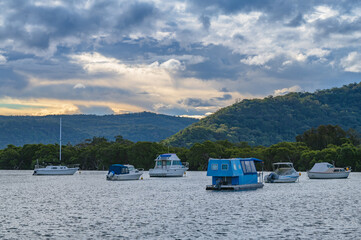 Late afternoon waterscape with boats and rain clouds