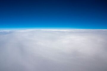 Aerial view of clouds against a clear blue sky with copy space