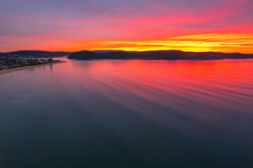 One hundred percent colourful cloud covered sunrise over the sea