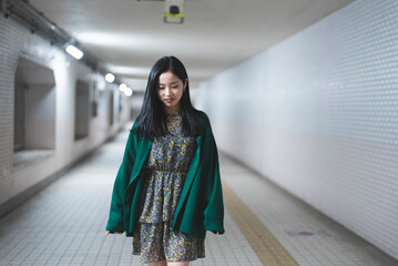 地下道を歩く若い女性
