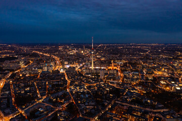 Amazing aerial panoramic night shot of city centre. Illuminated streets of large town. Fernsehturm TV tower, Berlin, Germany