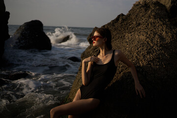 pretty woman in swimsuit island rocks posing summer