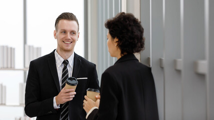 Colleagues drinking coffee together in office