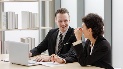 Happy businesspeople cooperating in office