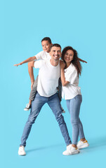 Happy interracial family on color background