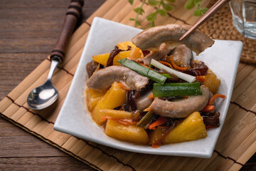 Eating pan-fried pork small intestine with pineapple.