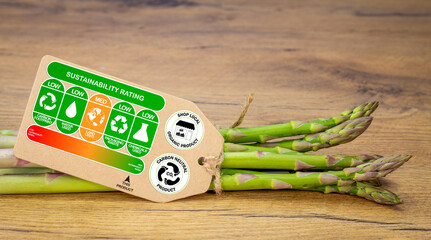 Sustainability rating label on organic asparagus with rating gradient for the product, carbon neutral and shop local labels, sustainable food concept