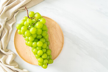fresh green grape on wood plate