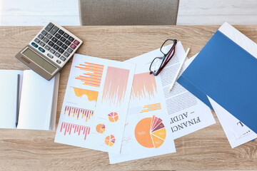 Documents with calculator at workplace in office, top view