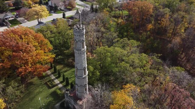 Drone rotate around battlefield house monument in Hamilton Ontario Canada, aerial close up of the main stone tower in the park