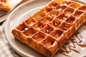 Plate with yummy Belgian waffle and jam on table, closeup