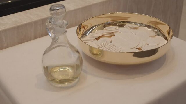 Consecrated communion hosts on a golden bowl, Christian Catholic Celebration