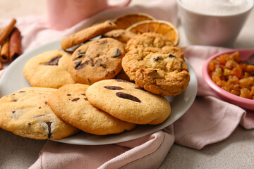 Plate of tasty homemade cookies with chocolate chips on white background