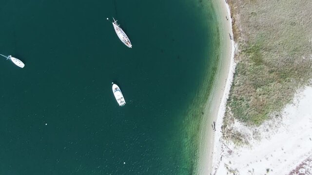 Aerial View Of Lighthouse Beach In Edgartown, Massachusetts With Edgartown Harbor Light Revealed. top-down