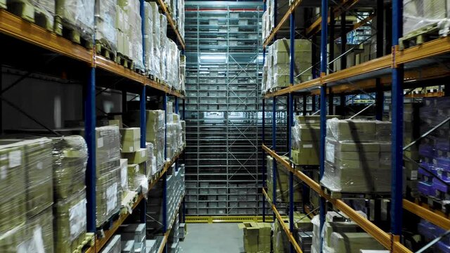 Multi-storey shelving systems used in big storage warehouse, drone flight