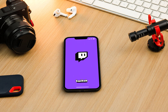 Twitch app on smartphone iPhone 13 Pro screen on wooden table. Content creator environment with keyboard, camera and mic. Rio de Janeiro, RJ, Brazil. November 2021