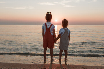 vacation at sea. A family walks along the beach. children holding hands