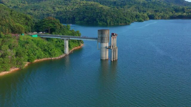 Drone flies over cement structure of Hatillo dam water pump station