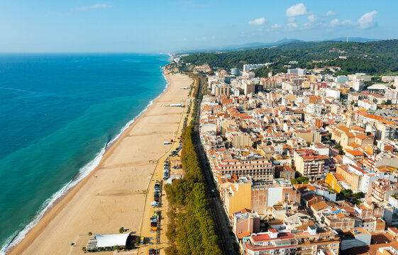 Aerial photo of Spanish town Calella with view of beach and residential buildings.