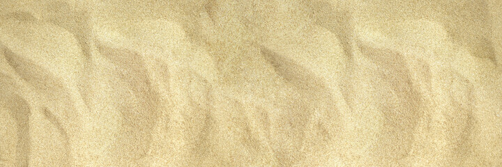 Uneven beach sand photo texture. Tropic sea coast top view. Natural smooth sand beach texture. Dry sand surface. Summer travel background. Tropical seaside holiday banner template.Top view