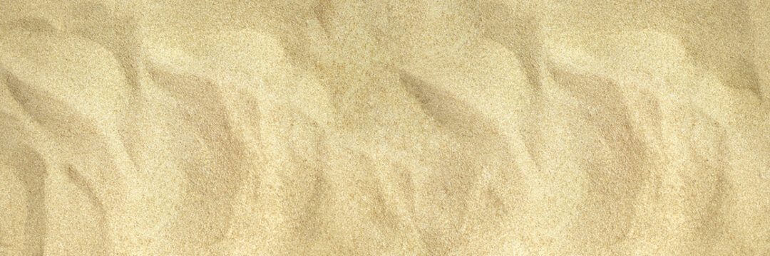 Uneven beach sand photo texture. Tropic sea coast top view. Natural smooth sand beach texture. Dry sand surface. Summer travel background. Tropical seaside holiday banner template.Top view