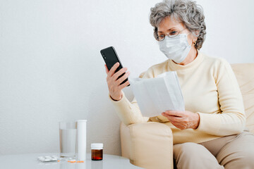 Online doctor consultation, remote medical assistance, seniors and healthcare. Sick elderly woman patient in face mask talking to doctor by video call on phone, reviewing prescription for medication - obrazy, fototapety, plakaty
