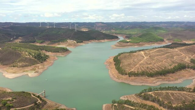 Aerial View Of Odeleite Dam And Barragem da bravura Near Wind Farm In Castro Marim, Algarve, Portugal.
