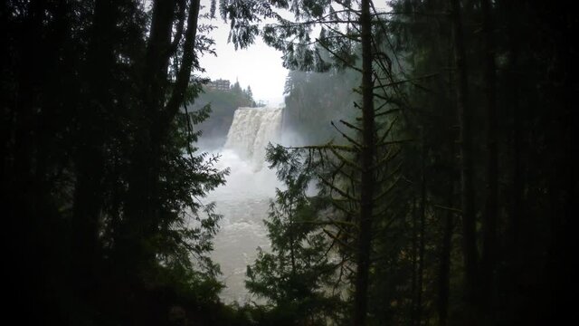 Dramatic Slow Motion Reveal of Snoqualmie Falls Waterfall Through Forest Trees