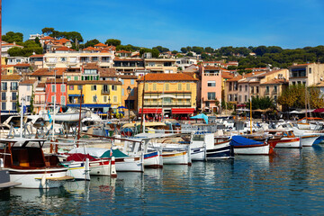 Fototapeta na wymiar Landscape with yachts and fishing boats in harbour of Cassis on sunny summer day, Provence, France