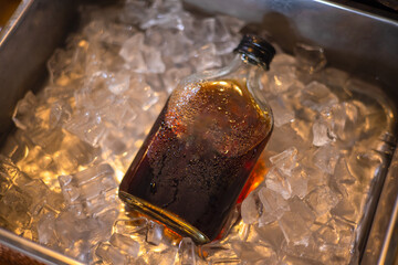  cold brew coffee bottle on ice blurred background