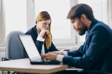 business man and woman sitting in front of a laptop teamwork internet technologies
