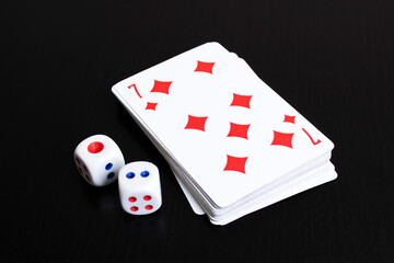 Deck of cards and two dice on wooden table