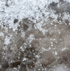 Crushed ice in a puddle as an abstract background.