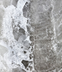 Crushed ice in a puddle as an abstract background.