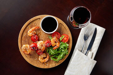 canapes with shrimp and tomato, sprinkled with sesame seeds with arugula, sauce and wine,Skewers 