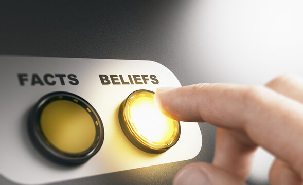 Finger pressing a button with the word beliefs intead of facts during a cognitive psychological experiment. Composite image between a hand photography and a 3D background.